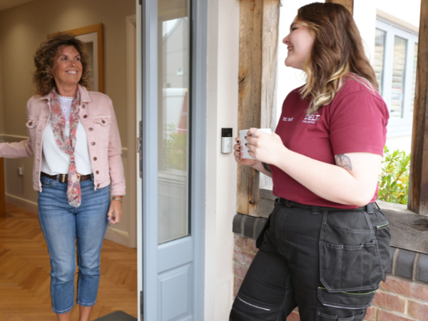 TEC Officer with woman at front door